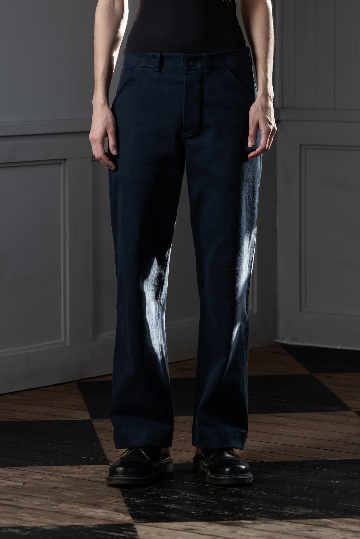 Front view of woman wearing MAYED dark navy Candiani denim straight-leg trousers